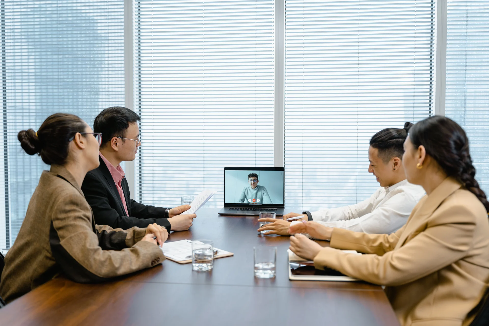 People in an office meeting set up for a video call